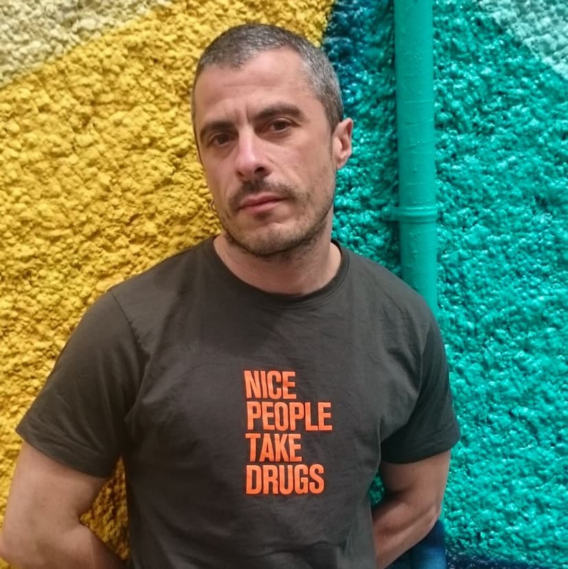 Doctor X wearing a t-shirt that says 'Nice People Take Drugs'.