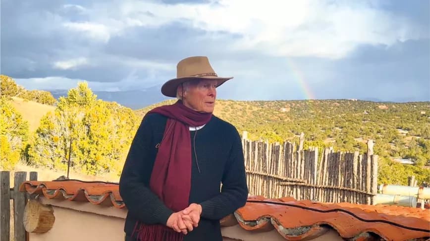 Leonard Pickard in Santa Fe, New Mexico, where he currently resides, during a videoconference intervention for a LEAP conference, with the rainbow behind him.
